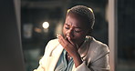Black woman, tired and yawn with computer at office, night and exhausted with project at media company. African person, burnout and fatigue with pc, brain fog or dark workplace at creative agency