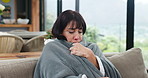 Cold, sick and woman with blanket at house from allergies, flu symptoms and blowing nose of virus. Mature person, tissue and sinus with nasal congestion, viral infection and recovery from influenza