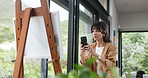 Artist, woman and phone with painting for picture, promotion of artwork and social media. Photography, painter and mature person with smartphone for online post, talent or creative canvas in house
