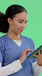 Reading, nurse and tablet with woman on green screen for healthcare, research and fertility clinic assistant. Medical professional, online records and obstetrics with person on studio background
