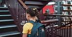 Child, girl and stairs in library for education, student and walking for learning or knowledge at academy campus. Scholarship, growth and development for literacy, study or project research at school