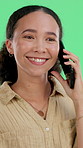 Smile, woman and talk with phone call in studio for discussion, networking and gossip with contact. Happy, female person and mobile for conversation, online chat and listening on green background