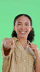 Face, fist pump and pointing with woman on green screen for celebration, motivation or success. Cheering, smile and winner with excited person isolated in studio for choice, satisfaction or selection