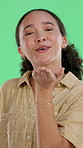 Face, woman and blow kiss on green screen for affection, romantic gesture and kindness emoji. Confidence, happy person and flirt sign for love connection, care expression and friendly goodbye to date