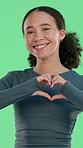 Face, heart hands and woman with fitness, green screen and smile with icon on studio background. Happy person, training or gesture for support, emoji or symbol for love, motivation or shape with care