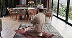 Muslim, man and praying with salah in home for gratitude, islamic faith and worship Allah on Eid. Male person, prayer and dua with spiritual belief, religious devotion and praise to God for tradition