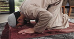 Muslim, man and praying with mat on floor, worship or faith with respect, devotion and Islamic belief. Bow, prostrate or male person with trust in Allah, God and prayer with Islam in the home