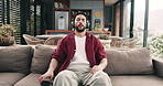 Phone, headphones and man meditate in home with music, peace and calm. Mobile, audio and person breathing to relax in living room for streaming, mindfulness podcast and listen to healing frequency