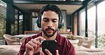 Mobile, meditation and man with headphones in home for music, peace and calm. Phone, audio and person breathing to relax in living room, streaming mindfulness podcast and listen to healing frequency
