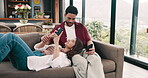 Couple, relax and talk on sofa with phone for social media, online communication and bonding together. Love, married people and tech for browsing internet, conversation and mobile app in apartment.