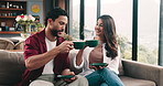 Couple, toast coffee and happy on sofa with celebration, anniversary and bonding in living room at home. Man, woman and smile with drinks, milestone or excited with memory on couch at apartment