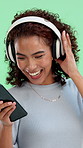 Green screen, smartphone and woman with headphones, dancing and subscription for music and playlist. Streaming, song and person with tech for entertainment, rhythm and happy with mobile app in studio