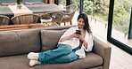 Happy woman, relax and scroll on sofa with phone for social media, online communication and connection. Above, female person and tech in home for browsing internet, mobile app chat and networking.