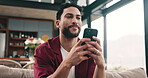 Social media, thinking or happy man with phone on sofa, post caption and update message on network app. Contemplation, comment or person with mobile for communication, reply ideas and texting in home