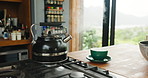 Kitchen, gas stove and kettle boiling with steam whistle for tea, mug and morning drink to start day. Home, burner and hot water in container for coffee, heat liquid and metal appliance in house