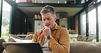Confused, man and online with laptop, home and reading mistake on article, thinking and remote work. Journalist, reflection and mature person with tech for story, typing or freelance project in house