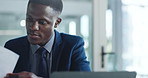 Reading, document and man with laptop, office and multitasking for deadline, budget review and notes. Busy, financial analyst and black person with paperwork for asset management, planning and online