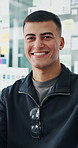 Face, business and man in workplace, smile and career ambition with product development. Happy person, employee and design agency with pride, startup or professional with positive mindset or expert