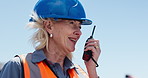 Outdoor, talking and woman with radio on construction site for contact, inspection and planning. Architect, supervisor and mature person with instruction for building project, renovation or feedback