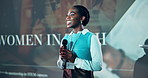 Presentation, speech and black woman with microphone, conference and smile with tech seminar. African person, presenter and expert with happiness, communication and female empowerment with ideas