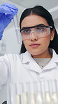 Medical, research and woman in lab, test tube and results with experiment, safety glasses and science. Person, researcher or scientist in workplace, vaccine cure and microbiology with liquid bacteria