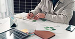 Hands, person and writing notes in office for planning, data analysis and ideas for renewable energy. Man, notebook and tablet screen for reminder, sustainable planner and charts of solar panel sales