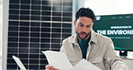 Business, man and reading documents in office for preparation on environment presentation. Male person, paperwork and tablet with sustainable report, climate change awareness and eco-friendly project