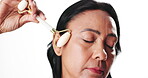 Skincare, woman face or roller in studio for anti aging, facial massage or prevent wrinkles for beauty. Lymphatic drainage, space or mature person with dermatology tool, self care or white background