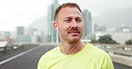 Earphones, thinking and man in city, fitness and listening to music, morning workout and wellness. Outdoor, athlete and healthy person in street, sound and podcast with radio, exercise and challenge
