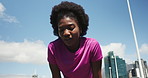Low angle, tired and black woman in city, fitness and exhausted with workout, sweaty and wellness. Outdoor, athlete and African person with training, fatigue or health with break, endurance and rest