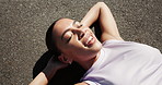 Relax, exercise and above of woman on road for recovery after workout, running and training outdoor. Happy, sports and person rest, breathe and laying on street for wellness, health and fitness break