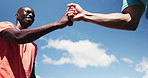 Fist bump, greeting and friends outdoor for fitness, teamwork celebration and bonding together. Low angle, happy people and secret handshake in city for workout goals, exercise support and wellness.