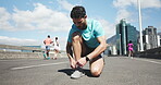 Athlete, man and tying shoes in city for getting ready, fitness preparation and exercise. Male person, lace and footwear with sports training, runner safety and marathon practice of outdoor challenge