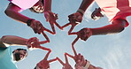 Fitness, mission and star with hands of people outdoor for training, support and collaboration. Running club, team and workout partners with low angle of runner on blue sky for connection and goal