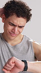 Fitness, fail and man with smart watch in studio for workout mistake, health goals and poor performance. Confused, white background and person with tech for tracking exercise, wellness and progress