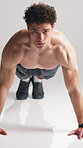 Face, man and push up in studio for fitness, workout or  strength training. Strong athlete, calisthenics and exercise on floor for health, body wellness or muscle development on white background