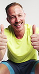 Fitness, face and man with thumbs up in studio for workout success, funny running feedback or relax. Laughing, athlete and yes emoji on white background for exercise review, wellness support or goals