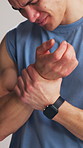 Wrist pain, exercise and man in studio with injury for fitness, training and workout accident. Sports risk, white background and person with inflammation, muscle strain and carpal tunnel for health