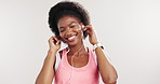 Black woman, earphones and dancing with fitness in studio, click smart watch and happy on white background. African person, energy and app with streaming subscription, break and listen to music