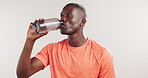 Black man, drinking water and fitness in studio with wellness, hydration and detox on white background. African person, bottle and aqua for electrolytes, exercise and mockup space with training break