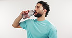 Fitness, drinking and man in studio with water for hydration, wellness and health for workout. White background, space and person with bottle, liquid and minerals for exercise, recovery and break