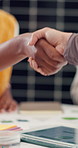 Handshake, agreement and business people in office with partnership, deal or collaboration. Creative project, meeting and magazine editor shaking hands with director for publishing in workplace.