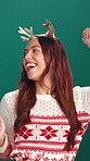 Happy, christmas and woman dancing in studio with festive music for tradition, fun or holiday. Smile, energy and female person with groove for xmas playlist, antlers and sweater by green background.