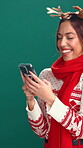 Studio, laugh and woman with smartphone, Christmas and planning for festive season with social media. Green background, search and person with mobile for Xmas inspiration, December and scroll on web