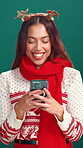 Studio, online and woman with smartphone, Christmas or planning for festive season with social media. Green background, laugh and person with mobile for Xmas inspiration, December and scroll on web