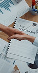 Above, handshake and business people in office with documents, agreement and company audit. Group, shaking hands or employees in workplace with graphs, partnership and charts for performance deal