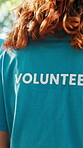 Volunteer, tshirt and back of woman at park for charity event, earth day project or NGO organization. Community outreach, support or person in nature for non profit prgram, climate change or activism