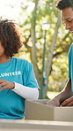 Volunteer, team and packing donation box at park for non perishable supplies, charity event or NGO. Happy group, people and help with grocery package outdoor for social responsibility and food drive