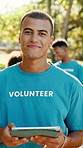 Volunteer, face and man in park on tablet for outreach program, charity event and community service. Portrait, nature and person on digital tech for ngo website, nonprofit and donation info outdoor