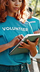 Volunteer, typing and woman in park on tablet for outreach program, charity event and community service. Happy, nature and person on digital tech for ngo website, nonprofit and donation info outdoor
